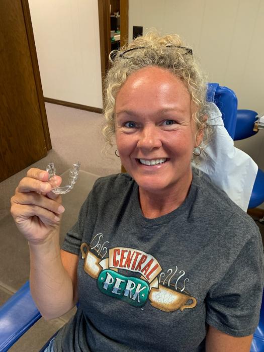 Kalamazoo patient holding clear aligners 