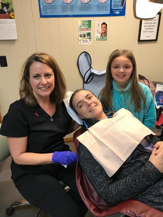 young kalamazoo patient smiling in the dental chair