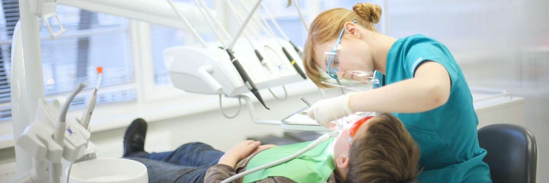 dental hygienist cleaning a patient's teeth in kalamazoo