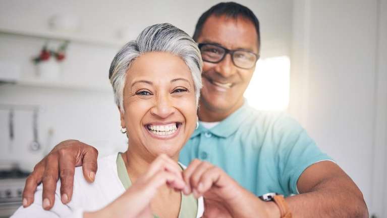 husband and wife smiling