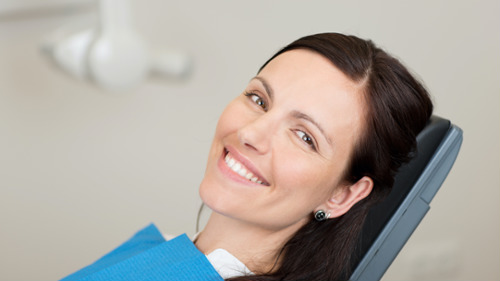 kalamazoo woman smiling while sitting in dental chair