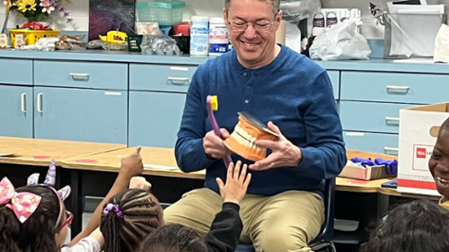 Dr ricahrdon teaching a classroom of children good oral health habits