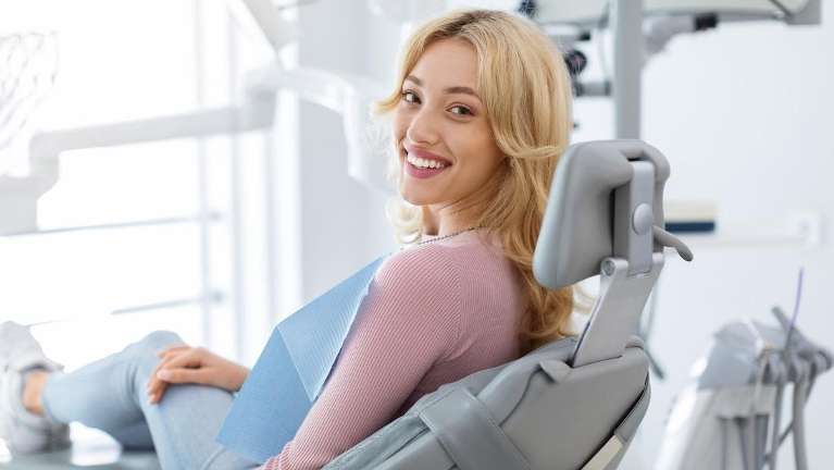 woman sitting in dental chair in her kalamazoo dental office