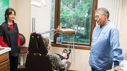 dr richardson and staff member speaking to kalamazoo patient about veneers