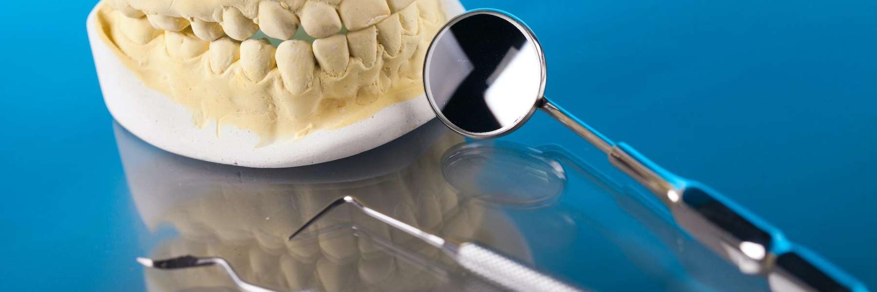 dental tools next to tooth mold