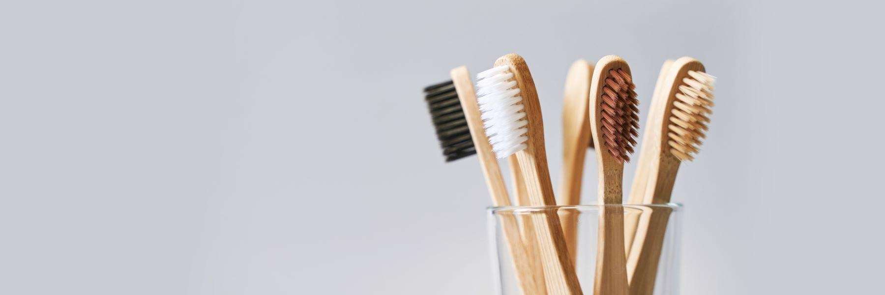 glass with toothbrushes in it