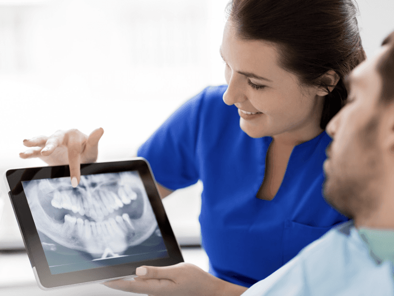 dentist showing patient their dental x-rays